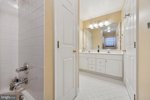 bathroom featuring washtub / shower combination and vanity