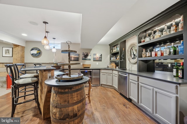 bar featuring decorative light fixtures, gray cabinets, stainless steel dishwasher, light hardwood / wood-style flooring, and beverage cooler