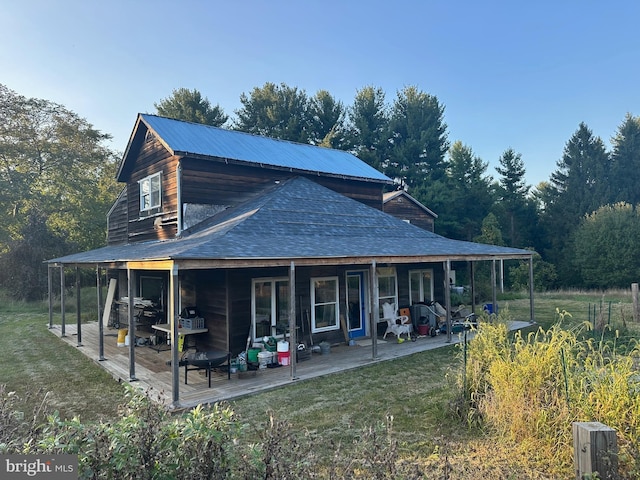 back of house featuring a patio area and a lawn