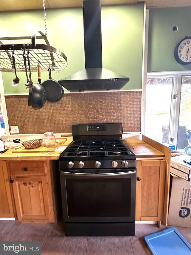 kitchen with tasteful backsplash, wood counters, extractor fan, and gas stove