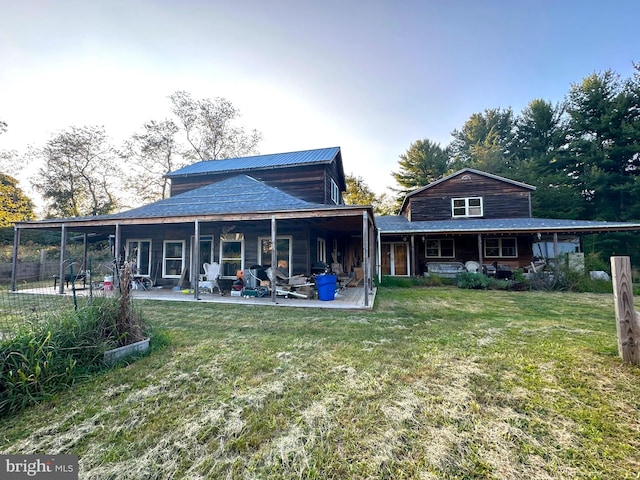 back of property featuring a yard and a patio