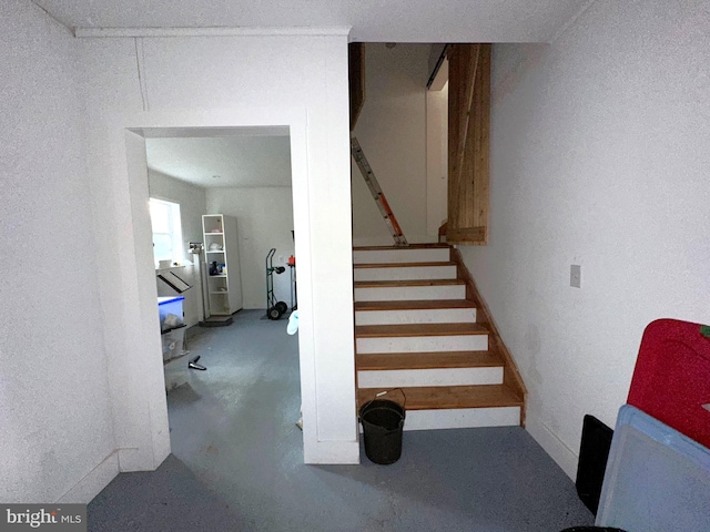 staircase with concrete flooring