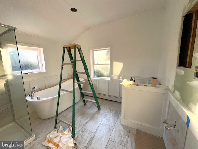 bathroom featuring lofted ceiling and independent shower and bath