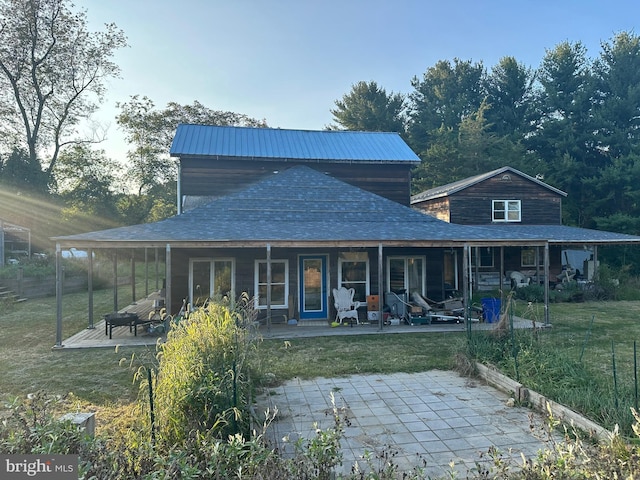 view of front of home with a patio area and a front yard