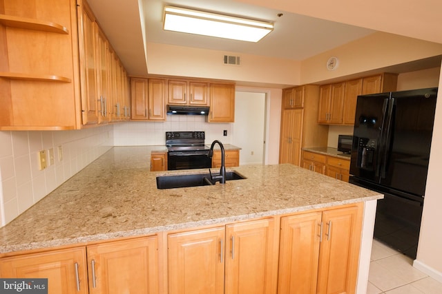 kitchen featuring sink, backsplash, light stone counters, black appliances, and kitchen peninsula