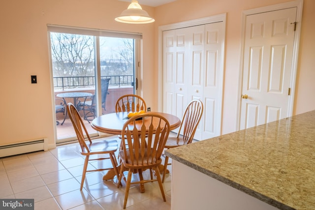 dining area featuring a baseboard radiator and light tile patterned flooring