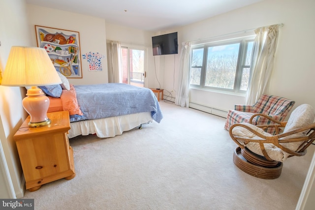 bedroom with baseboard heating and carpet