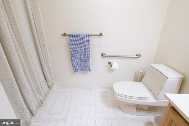 bathroom with vanity, a shower with curtain, and toilet