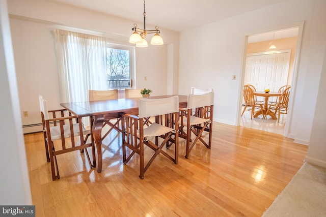 dining space featuring a notable chandelier and hardwood / wood-style flooring