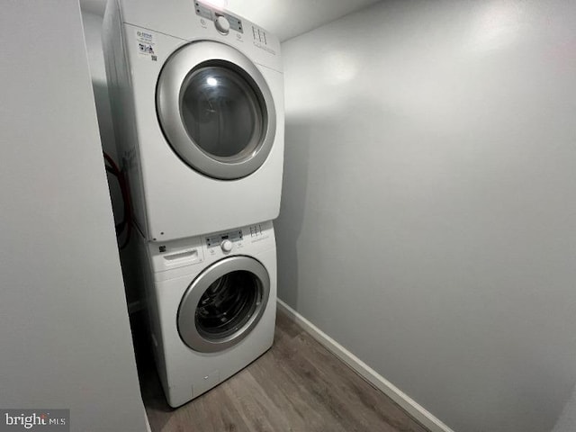 washroom featuring stacked washer / dryer and hardwood / wood-style floors