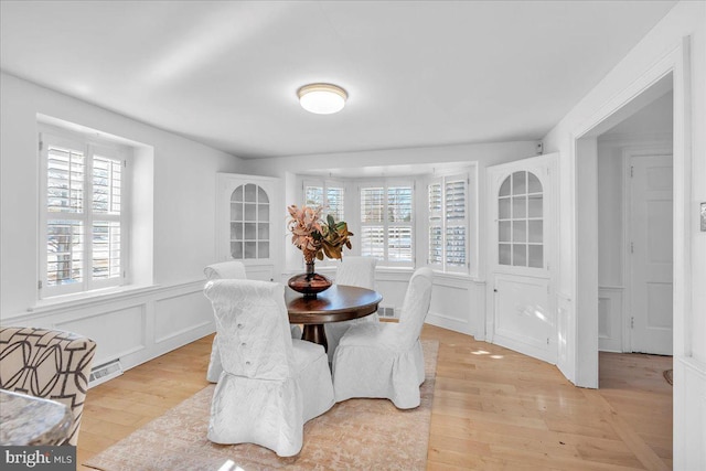 dining area featuring a healthy amount of sunlight and light hardwood / wood-style floors