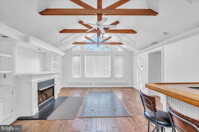 unfurnished living room featuring vaulted ceiling with beams, ceiling fan, and hardwood / wood-style floors