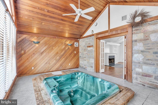 interior space with ceiling fan, wooden ceiling, and vaulted ceiling