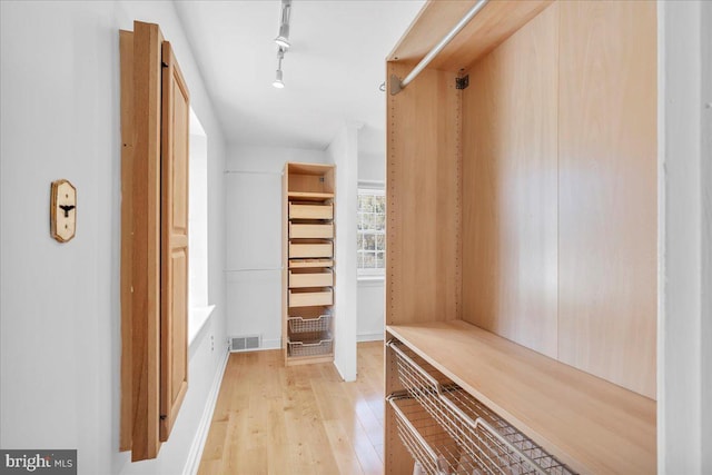 spacious closet featuring light hardwood / wood-style flooring