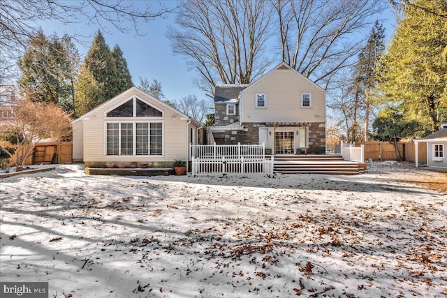 view of snow covered back of property