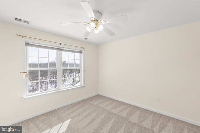 unfurnished room featuring ceiling fan and light carpet