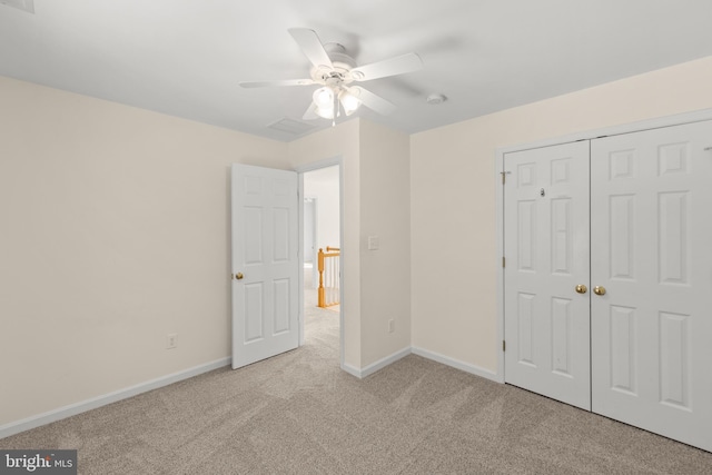 unfurnished bedroom with ceiling fan, a closet, and light carpet