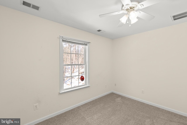 empty room featuring carpet floors and ceiling fan