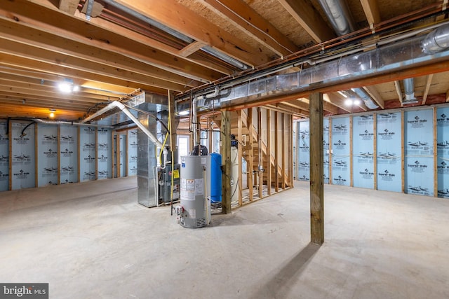 basement featuring gas water heater and heating unit