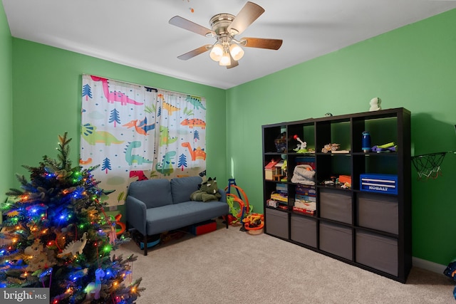 game room with ceiling fan and light colored carpet