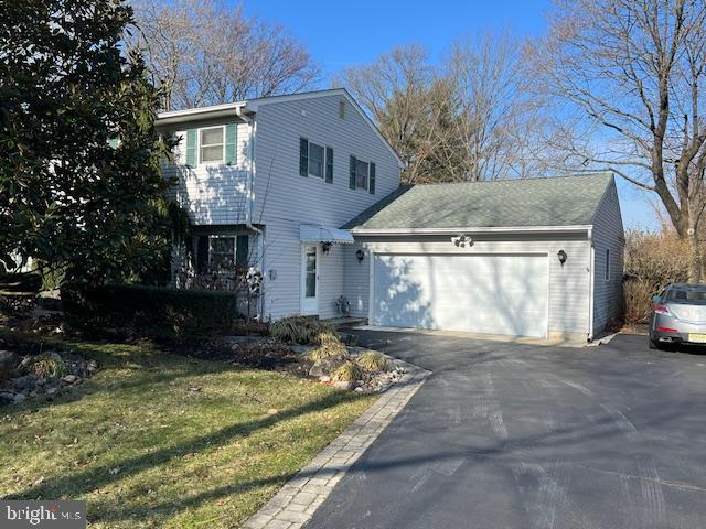 view of front facade with a front yard and a garage