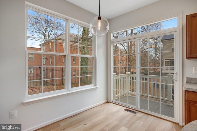 unfurnished dining area with light hardwood / wood-style floors