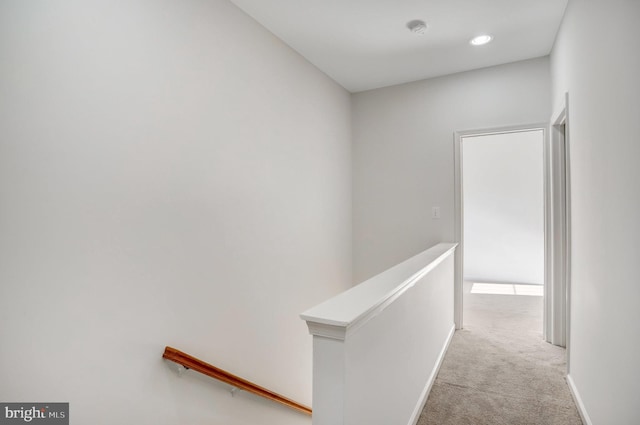 hallway with light colored carpet