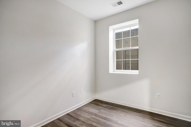 unfurnished room featuring dark hardwood / wood-style flooring