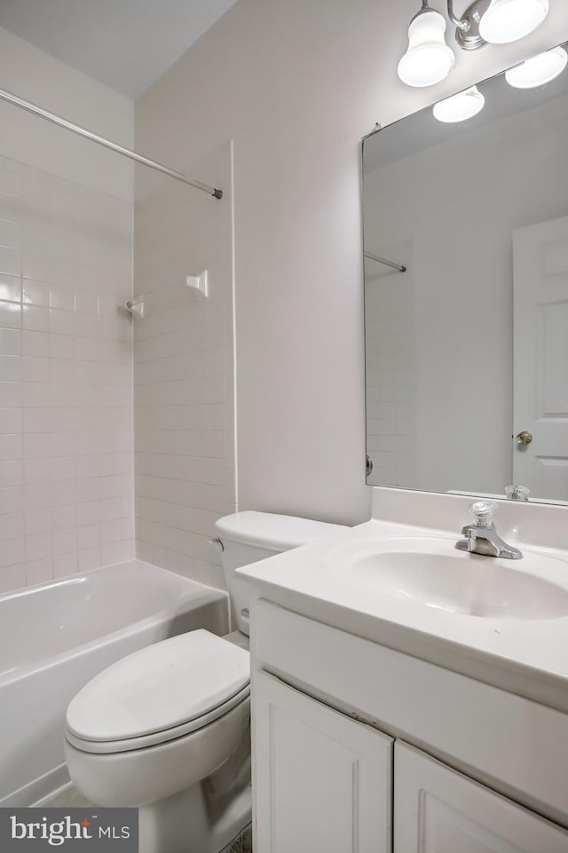 full bathroom featuring toilet, vanity, and tub / shower combination