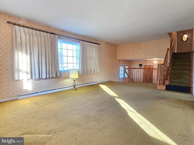 carpeted spare room featuring baseboard heating