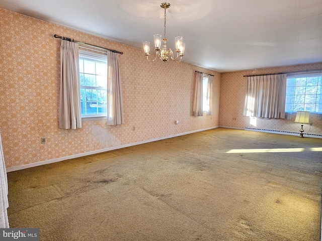 spare room with carpet, a baseboard radiator, and an inviting chandelier