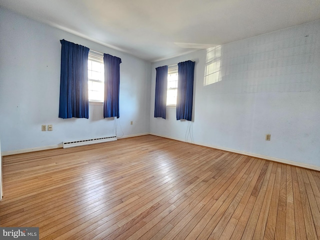 spare room with light hardwood / wood-style floors and baseboard heating