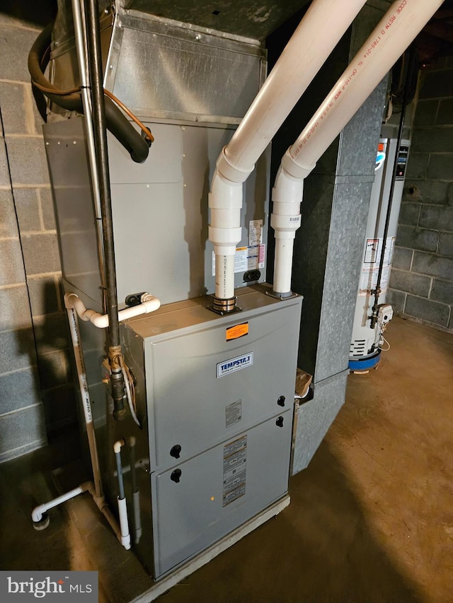 utility room featuring water heater