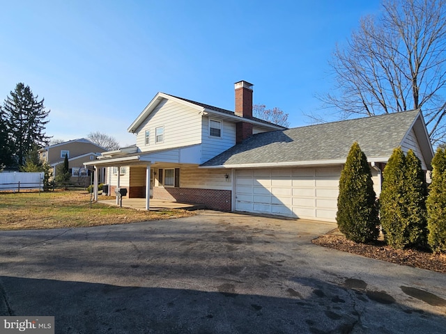 view of front of property with a porch and a garage