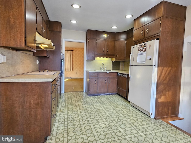 kitchen with sink, black dishwasher, white fridge, stovetop, and dark brown cabinets