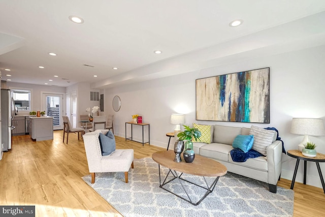 living room with light hardwood / wood-style flooring