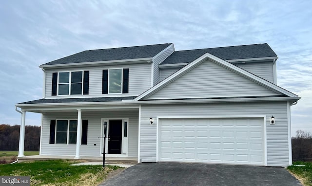 view of front property featuring a garage and covered porch