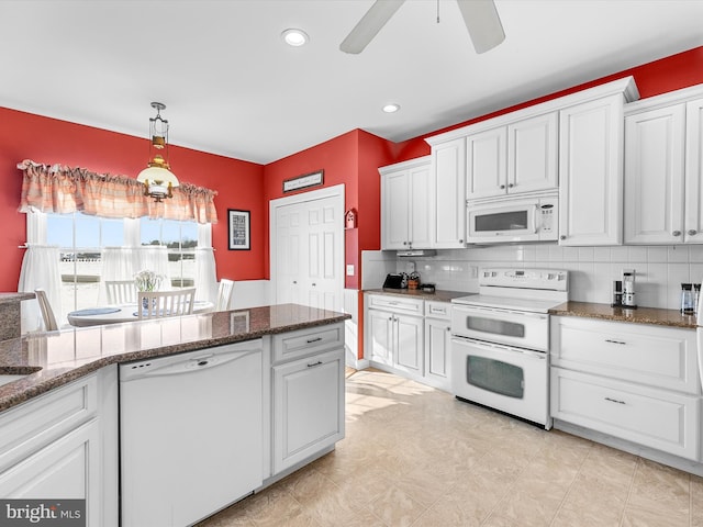 kitchen with ceiling fan, white appliances, white cabinetry, tasteful backsplash, and decorative light fixtures