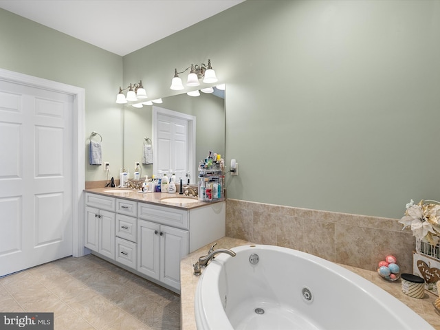 full bathroom with double vanity, a tub with jets, tile patterned flooring, and a sink