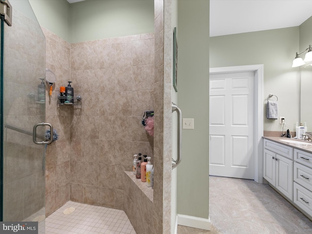 bathroom featuring a shower stall and vanity