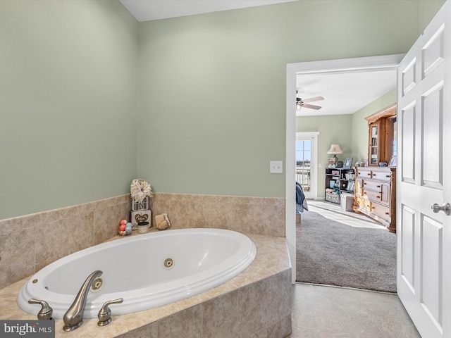 bathroom with ceiling fan, a jetted tub, and tile patterned floors