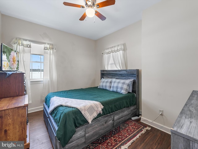 bedroom featuring a ceiling fan, baseboards, and wood finished floors