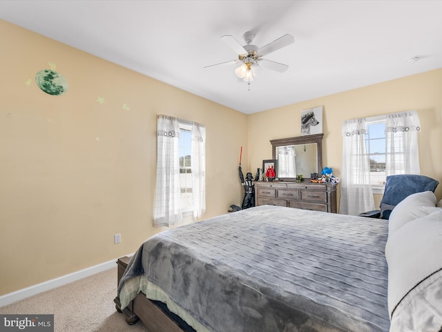 bedroom with carpet, baseboards, and a ceiling fan