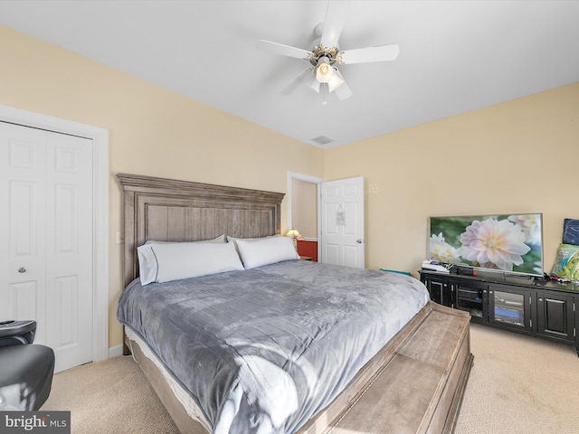 bedroom with visible vents, a ceiling fan, and light colored carpet