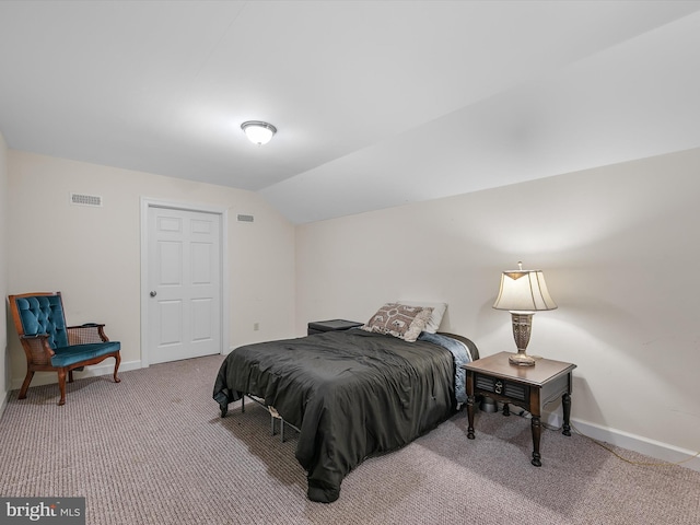 bedroom with lofted ceiling, carpet, visible vents, and baseboards