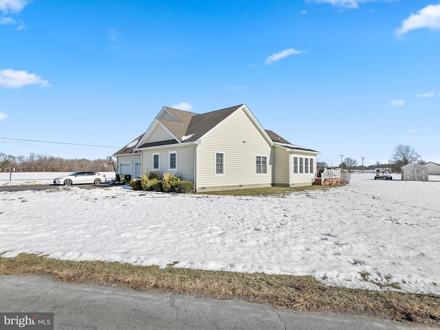 view of snowy exterior featuring crawl space