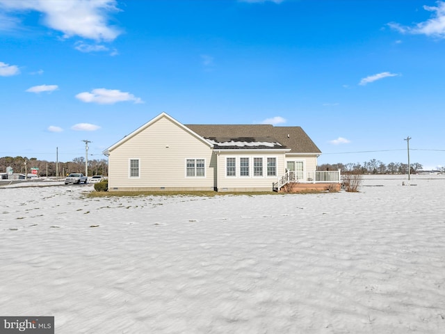 rear view of property featuring crawl space