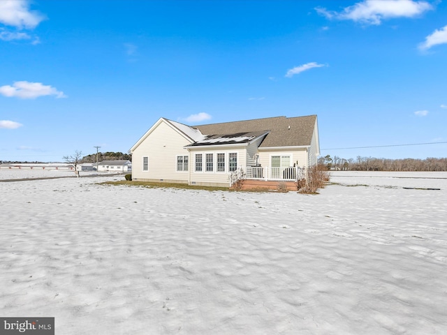 rear view of house with crawl space and a wooden deck