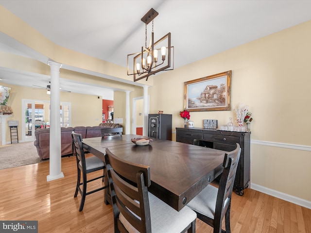 dining area featuring light wood-style floors, decorative columns, baseboards, and ceiling fan