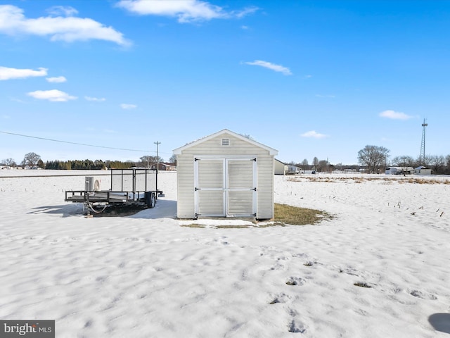 snow covered structure with a storage unit and an outdoor structure